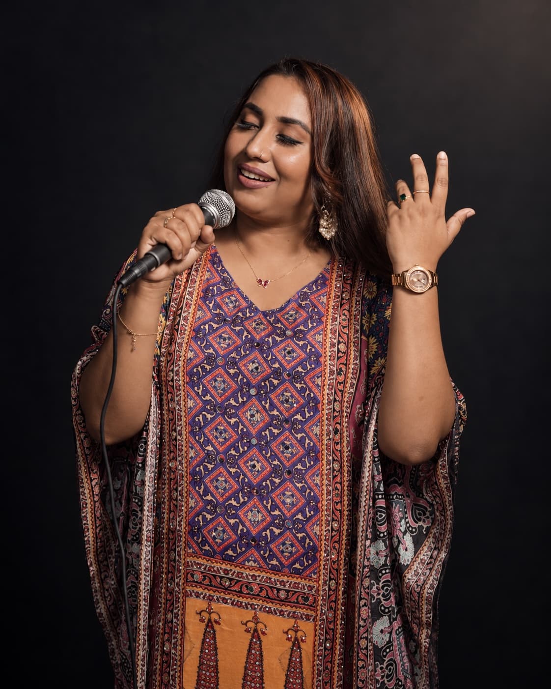 Originals Orchestra vocalist singing against a dark backdrop